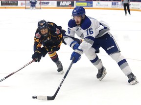 Nick DeGrazia, right, of the Sudbury Wolves, attempts to skate past Kashawn Aitcheson, of the Barrie Colts, during OHL exhibition action at the Sudbury Community Arena in Sudbury, Ont. on Tuesday September 20, 2022. John Lappa/Sudbury Star/Postmedia Network