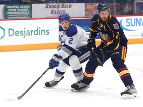Joshua Hoover, left, of the Sudbury Wolves, is shadowed by Connor Punnett, of the Barrie Colts, during OHL exhibition action at the Sudbury Community Arena in Sudbury, Ont. on Tuesday September 20, 2022. John Lappa/Sudbury Star/Postmedia Network
