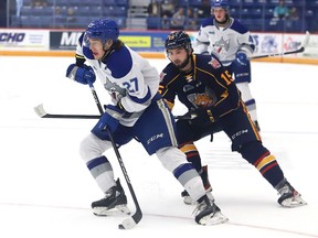 Quentin Musty, left, of the Sudbury Wolves, skates around Jacob Frasca, of the Barrie Colts, during OHL exhibition action at the Sudbury Community Arena in Sudbury, Ont. on Tuesday September 20, 2022. John Lappa/Sudbury Star/Postmedia Network