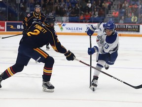 Kocha Delic, right, of the Sudbury Wolves, fires the puck past Connor Punnett, of the Barrie Colts, during OHL action at the Sudbury Community Arena in Sudbury, Ont. on Friday September 30, 2022. John Lappa/Sudbury Star/Postmedia Network