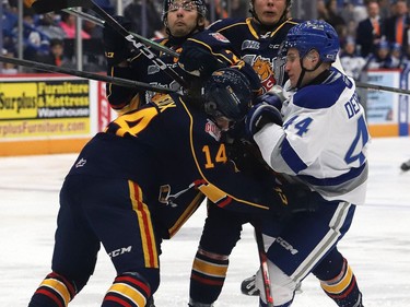 Michael Derbidge, right, of the Sudbury Wolves, is knocked to the ice during OHL action against the Barrie Colts at the Sudbury Community Arena in Sudbury, Ont. on Friday September 30, 2022. John Lappa/Sudbury Star/Postmedia Network