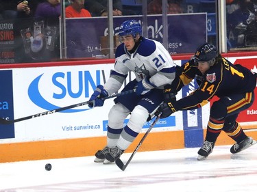 Alex Pharand, left, of the Sudbury Wolves, skates around Ian Lemieux, of the Barrie Colts, during OHL action at the Sudbury Community Arena in Sudbury, Ont. on Friday September 30, 2022. John Lappa/Sudbury Star/Postmedia Network