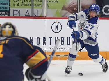 Quentin Musty, right, of the Sudbury Wolves, fires the puck at Ben West, of the Barrie Colts, during OHL action at the Sudbury Community Arena in Sudbury, Ont. on Friday September 30, 2022. John Lappa/Sudbury Star/Postmedia Network