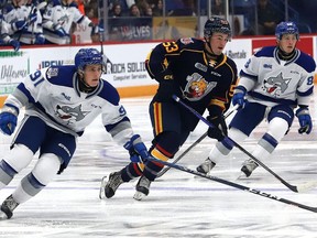 Evan Konyen, left, of the Sudbury Wolves, chases after the puck during OHL action against the Barrie Colts at the Sudbury Community Arena in Sudbury, Ont. on Friday September 30, 2022.
