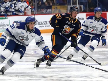 Evan Konyen, left, of the Sudbury Wolves, chases after the puck during OHL action against the Barrie Colts at the Sudbury Community Arena in Sudbury, Ont. on Friday September 30, 2022. John Lappa/Sudbury Star/Postmedia Network