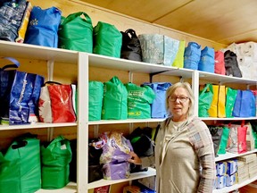 Cathy Beaton, General Manager of the Cochrane Food Bank stands beside food bags prepared for residents of Cochrane who rely on the facility for food staples. This is only a fraction of what is provided throughout the month to almost 200 local families.