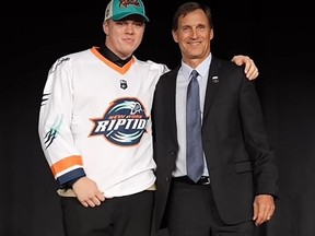 Tyler Davis (left) is greeted by National Lacrosse League executive vice-president Brian Lemon after being drafted by the New York Riptide in Toronto on Sept. 10. Contributed photo
