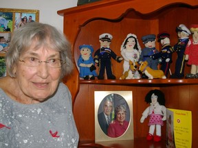 Grace Kolb poses with the Royal Family she has knitted, including Queen Elizabeth. The 94-year-old senior recalls the late monarch as a "wonderful" person. (Eric Bunnell/Special to Postmedia Network)