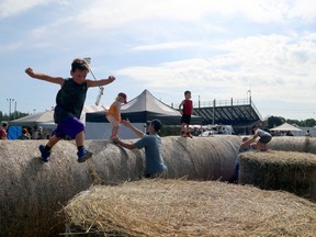 No midway no problem at the Owen Sound Fall Fair. Jackson Leblance, 8, jumps around on bales of hay set up for the kids at Victoria Park. Greg Cowan/The Sun Times