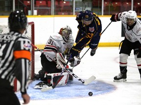 Beau Jelsma leaps between goaltender Nick Chenard and defender Taos Jordan while chasing a loose puck in the second period as the Owen Sound Attack host the Barrie Colts in the Attack's preseason finale inside the Harry Lumley Bayshore Community Centre on Sept. 24, 2022. Greg Cowan/The Sun Times