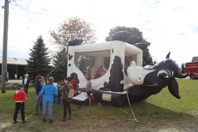 Children enjoy the bouncy cow at the Fall Day at the Farm event just east of Owen Sound Saturday. Hosted by the Parkin family and presented by Owen Sound Harvest for Hunger, the event supports Canadian Foodgrains, which helps feed the less fortunate in the world through emergency food assistance, helping train others to grow their own food and engaging Canadians and government. Greg Cowan/The Sun Times