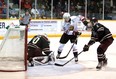 Nick Suzuki tries to tuck a puck between the legs of 16-year-old goaltender Tye Austin on a partial breakaway in the first period of the Owen Sound Attack and Peterborough Petes game at the Harry Lumley Bayshore Community Centre on Oct, 27, 2019. Greg Cowan/The Sun Times