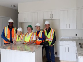 Christenson Developments opened its doors Saturday, giving locals and visitors a sneak peek inside the Manor in Whitecourt during its first open house. Checking out one of the full kitchens in the residents’ suites were (l-r) tour guide Cecil Gwinji and attendees Kay Brunet, Donna Glover, and Noella and Robert Lapointe. Christenson reps spoke about how construction is progressing and when residents might be able to move into the much-anticipated facility.