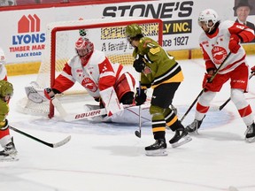 Matvey Petrov of the visiting North Bay Battalion beats Soo Greyhouhnds goaltender Charlie Schenkel in the final second of the second period in Ontario Hockey League action Saturday night.