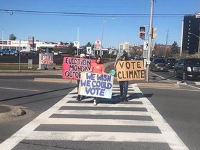 Members of Fridays For Future demonstrate at the Four Corners this past Friday. The group is calling on Sudburians to exercise their democratic right on Oct. 24.