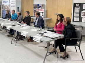 Greater Sudbury's incument mayor, Brian Bigger, speaks at a podium while fellow candidates Evelyn Dutrisac, Don Gravelle, Bob Johnston, Devin Labranche, Paul Lefebvre, Miranda Rocca-Circelli and Mila Wong listen during an all-candidates meeting at the Parkside Older Adult Centre on Saturday afternoon. Ben Leeson/The Sudbury Star/Postmedia Network