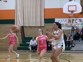 North Park Collegiate's Molly Adams awaits a pass from a teammate while Audra Krukowski of St. John's College looks on during an Athletic Association of Brant, Haldimand and Norfolk senior girls basketball game on Tuesday at NPC.