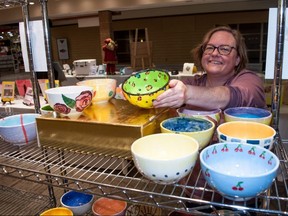 Lisa Stanley, the House of Blessing’s development co-ordinator, displays one of the hand-painted bowls on sale during the food bank’s signature Empty Bowls fundraiser this month. Purchasing a bowl allows donors access to a seven-day online auction opening Oct. 29 with over 100 items. (Chris Montanini/Stratford Beacon Herald)