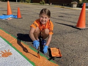 McKenna Bonner, a Grade 4 student at Bruderheim School painted a local sidewalk orange to help build understanding the importance of reconciliation and recognize National Day for Truth and Reconciliation. Photo supplied