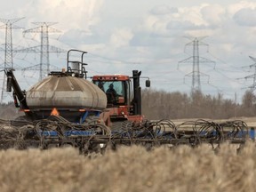 Pete Neustaeter and Keith Goutbeck seed a field for Share the Harvest's 20th annual crop for the Canadian Foodgrains Bank outside of Gibbons north of Edmonton on May 12, 2022. IAN KUCERAK/Postmedia/file