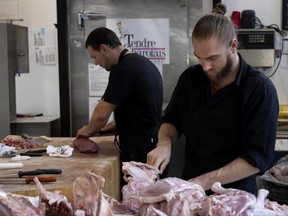 Jimmy Bodic, a butcher at Les Fermes St-Vincent, sections turkey at the Atwater Market. Fermes St-Vincent is the only fully organic butcher at the market, in Montreal on Friday, October 7, 2022. (Allen McInnis / MONTREAL GAZETTE)