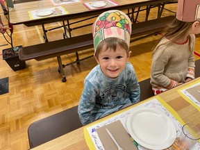 Kindergarten student Ryker is all smiles at the Thanksgiving dinner held at noontime Friday at Our Lady Of Fatima School. GREG ESTABROOKS