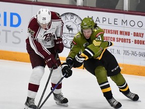 Rookie Ethan Procyszyn of the visiting North Bay Battalion vies with Jax Dubois of the Peterborough Petes in Ontario Hockey League action Thursday night.