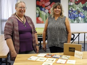 Shelly Malmberg (left) and Leslie Claringbull (right) stand together with their Stampin' Up example cards on the table,  just before hosting their first ever card making class at The Annex in Pincher Creek, located at 753 Kettles Street, on Oct. 5.