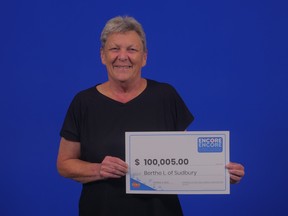 Berthe Lajambe celebrates her $100,005 lottery win while collecting the prize at OLG headquarters.