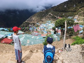 Spruce Grove's Xavier (left) and Zack (right) Sapkota stare out over Namche Bazaar, Nepal, during their first journey to the South Base Camp of Mount Everest with their parents Nabraj and Maria in May 2022. Photo by Nabraj Sapkota.