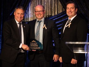McCutchen and Pearce Professional Corporation partners Craig Pearce (centre) and Michael McCutchen receive from Stratford Mayor Dan Mathieson the Stratford and District Chamber of Commerce Business Excellence Award for Business of the Year. (Photo courtesy DavidIAm Photography)