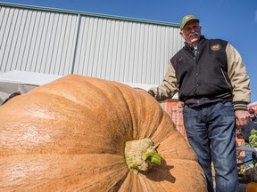 Norm Kyle from Ennismore stands alongside his first place prize winning pumpkin weighing in at 1658.5 pounds which took the top prize at this year's Pumpkinfest in Wellington. ALEX FILIPE