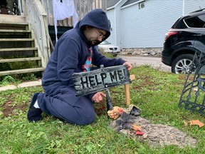 Jerrid Larochelle puts the finishing touches on his Halloween display at 361 Park St. Larochelle says he was determined not to let his developmental disabilities and finances stop him from getting into the Halloween spirit.