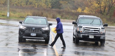 Pamphlets are distributed in the rain before a rosary rally at Our Lady of Fatima grotto at Our Lady of Good Counsel Catholic Church in Sault Ste. Marie, Ont., on Saturday, Oct. 15, 2022. (BRIAN KELLY/THE SAULT STAR/POSTMEDIA NETWORK)