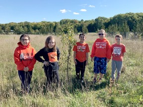 Grade 4 students, from left, Avery Panton, Autumn Bryan, Maximus Panamick, Parker Johnston and Shawn McKelvie stand in the green space that will be transformed at Central Manitoulin Public School.