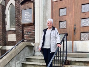 Bette Lefebvre descends the steps of Knox Presbyterian Church following a closing service on Sunday.