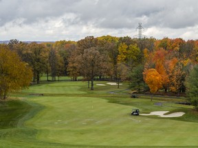 A golfer drives a golf cart as they progress through the Black Bear Ridge golf course as the trees around them change colour on Tuesday in Corbyville, Ontario. ALEX FILIPE