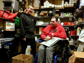 Despite being diagnosed with cerebral palsy at a young age, Mitchell's McKenzie Hinz (right) lives a rich and fulfilling life in which he works three jobs, volunteers in the community and is beloved by his circle of family, friends, support workers and seemingly everyone he meets.  Recently, Hinz was featured in a documentary detailing how a local organization, Facile Perth, has been helping him realize his dreams.  Pictured, Lex Brooks -- Hinz's former support worker and a server at Joe's Diner in Stratford -- and Hinz break down boxes in the back room at Joe's Diner where he works for a couple hours every Thursday afternoon.  Galen Simmons/The Beacon Herald/Postmedia Network