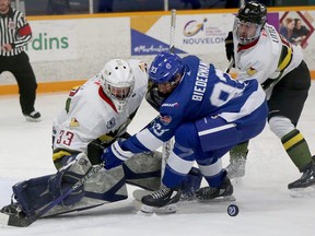 Greater Sudbury Cubs forward Billy Biedermann (93) battles for a puck in front of Powassan Voodoos goaltender Kannon Flageolle (33) and defenceman Alex Little (9) during first-period NOJHL action at Gerry McCrory Countryside Sports Complex in Sudbury, Ontario on Thursday, October 20, 2022.