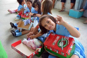 Children receiving Operation Christmas Child shoeboxes.