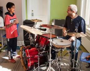 Toronto-based drummer Erik Samuel offers a quick lesson to Alireza Sachani at the Stratford Public Library on Saturday.  The library was celebrating the fifth anniversary of its MakerSpace.  Chris Montanini/Stratford Beacon Herald