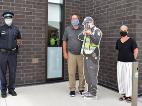 Const. Wes Coast, a life-sized aluminum cutout of a police officer, was found in a ditch along Ausable Line in South Huron. The cutout, which was introduced to the area in 2021, is used to deter speeders and promote safe driving habits. From left are Const. Jamie Stanley, Bluewater Coun. Alwyn Vanden Berg and Cathie Simpson of West Wawanosh Mutual Insurance showing off Const. Wes Coast in 2021. Dan Rolph