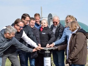 Municipal, provincial and federal government officials and industry representatives turn a renewable natural gas valve on Oct. 14 outside Ilderton to mark the launch of Stanton Farms' newly expanded biogas plant that will supply Ontario's natural gas distribution system. Calvi Leon