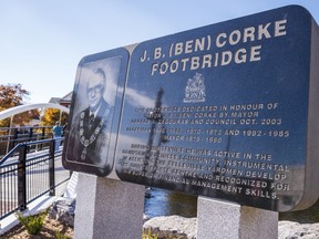 A historical plaque for former mayor J. Ben Corke stands beside the newly reopened footbridge named after him on Wednesday in Belleville, Ontario. ALEX FILIPE