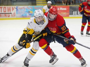 Duncan Grube of the Trenton Golden Hawks and Jaxen Boyer of the Wellington Dukes battle for position  during the third period Friday night. There wasn’t much give in the first meeting of the year between the two rivals as Trenton took a 2-1 win. Ed McPherson / OJHL Images