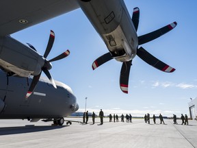 Members from 8 Wing Operational Squadron prepare to pull a Lockheed C-130 Hercules in support of United Way HPE on Thursday in Trenton, Ontario. ALEX FILIPE