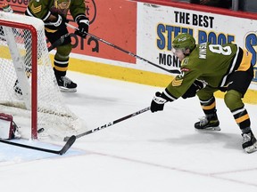 Avery Winslow of the visiting North Bay Battalion attempts to redirect the puck past Guelph Storm goaltender Dixon Grimes in their Ontario Hockey League game Sunday. The Troops wrapped up a three-game road trip.