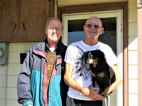 Standing where he last stood more than 50 years ago. Ferucio "Joe" Celotto (left) on the porch of his birthplace at 318 William St., Wallaceburg. With him is Dallas Smith and Sweety. Photo taken Oct. 22, 2022. John Martinello photo