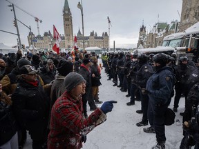 Police move in to clear downtown Ottawa near Parliament hill of protesters after weeks of demonstrations on Saturday, Feb. 19, 2022. The much-anticipated public inquiry into the federal government's unprecedented use of the Emergencies Act during “Freedom Convoy” protests last winter begins Thursday. THE CANADIAN PRESS/Cole Burston