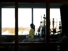 A nurse looks outside while in the intensive care unit at the Humber River Hospital in Toronto on Tuesday, January 25, 2022. Ontario's nursing college can now start allowing internationally educated nurses to practice while they work toward full registration. THE CANADIAN PRESS/Nathan Denette